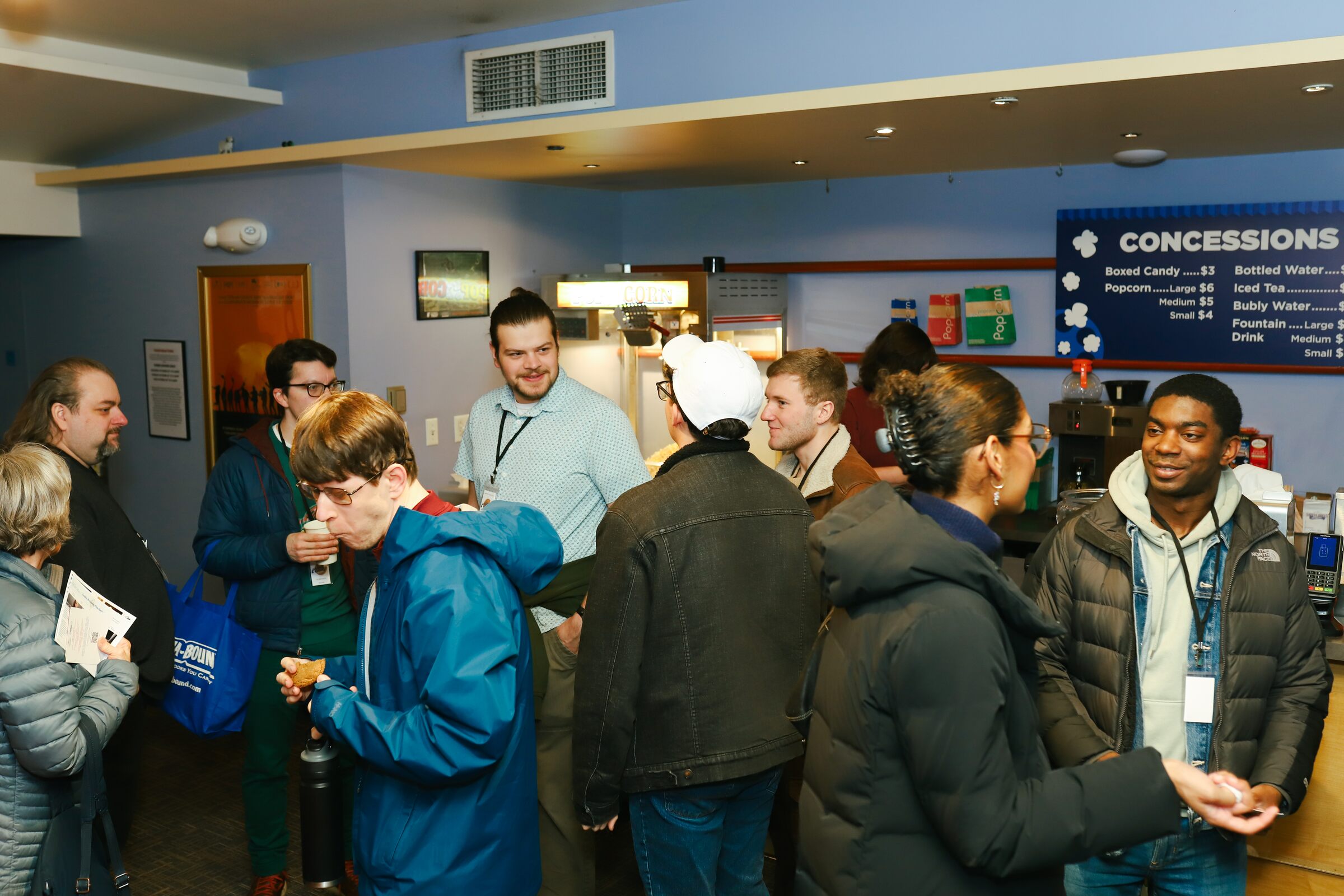 Festivalgoers chatting near the Harris Theater concessions during the pre-show mixer