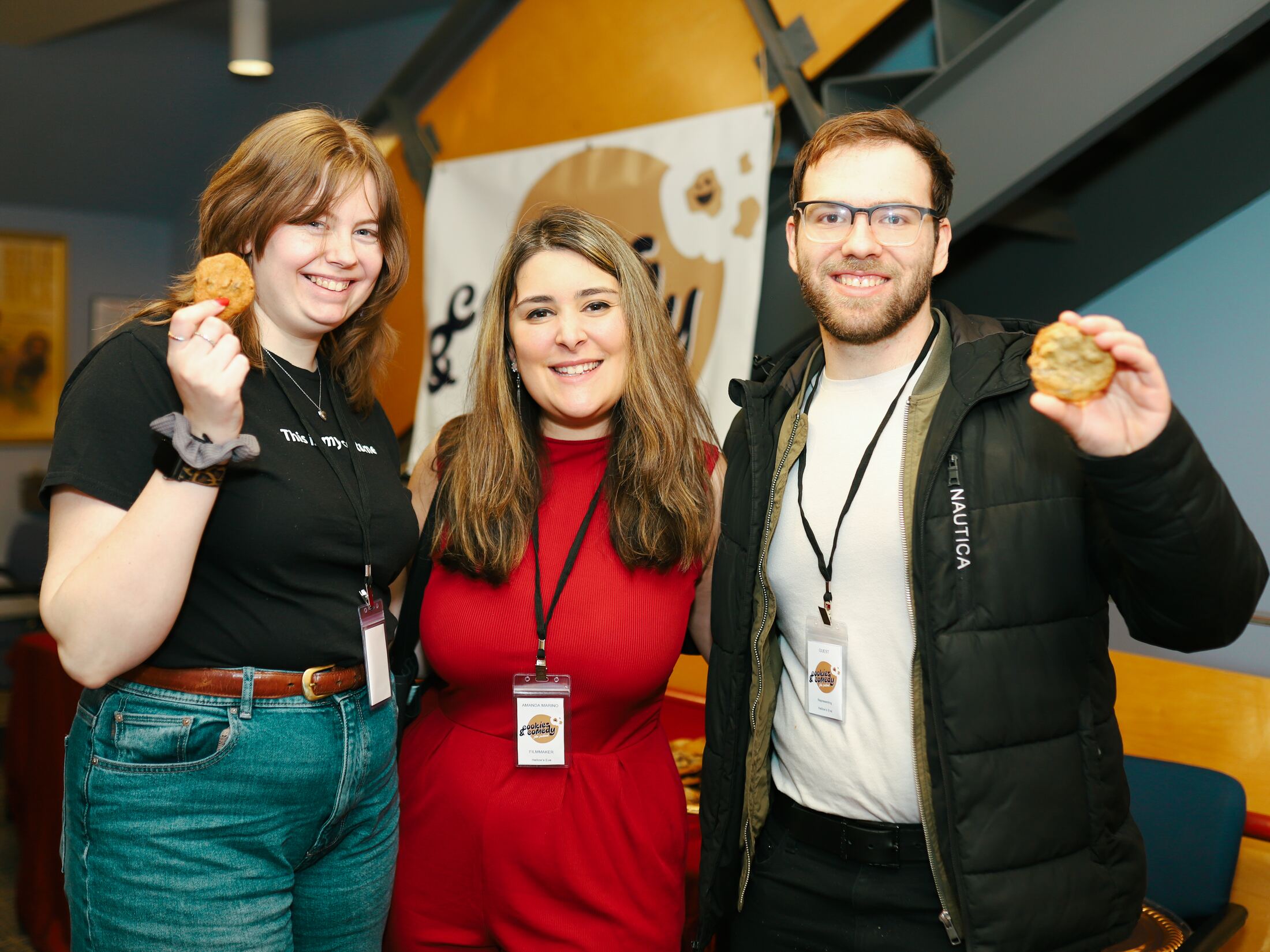 Members of the Hallow's Eve team posing with cookies in the theater lobby
